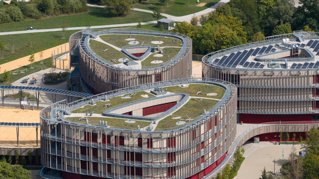 Durmersheim Germany 12 September 2026 Aerial view of Wilhelm Hausenstein Gymnasium featuring modern architecture with green roofs solar panels and surrounding parkland.