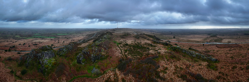Aerial view of the Roc h Trevezel rocky ridge and surrounding moorland under a dramatic cloudy sky in Plouneour Menez Brittany France.
