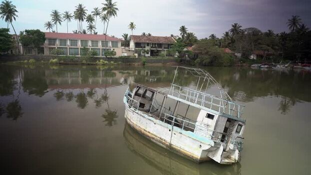 View of an abandoned boat hull on a river Sri Lanka. View of an abandoned boat hull on a river Sri Lanka.