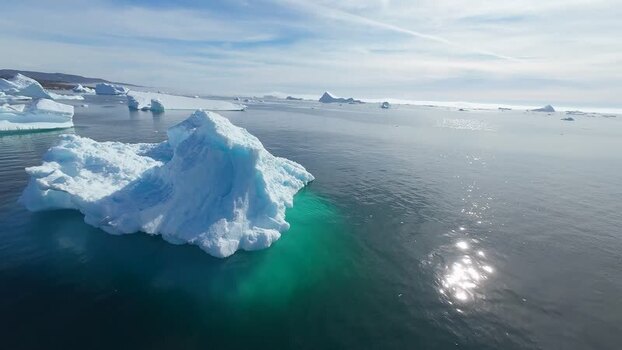 FPV aerial view of icebergs floating in the ocean Greenland. FPV aerial view of icebergs floating in the ocean Greenland.