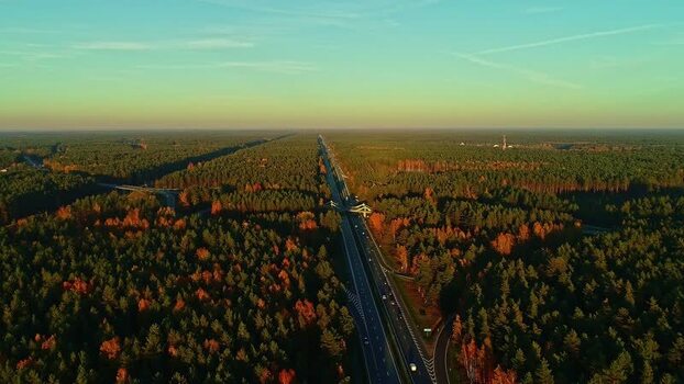 Aerial view of highway through forest Latvia.