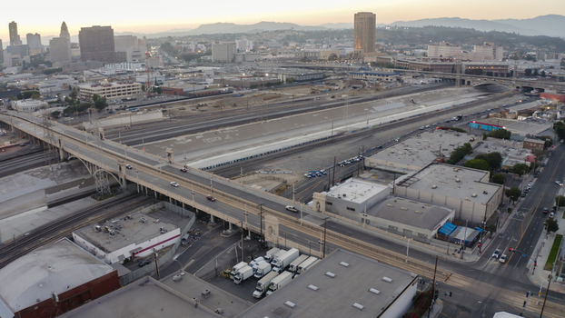Aerial view of the 6th Street Viaduct spanning the Los Angeles River channel with the city skyline in the background and urban infrastructure in Los Angeles California United States. Aerial view of the 6th Street Viaduct spanning the Los Angeles River channel with the city skyline in the background and urban infrastructure in Los Angeles California United States.