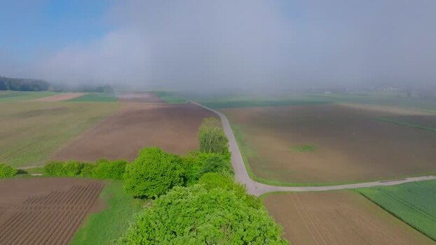 Aerial view of agricultural fields and road under fog Switzerland. Aerial view of agricultural fields and road under fog Switzerland.