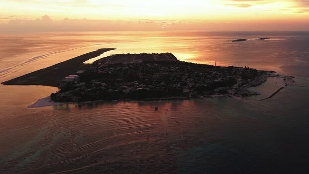 Aerial view of Kudahuvadhoo island at sunset Maldives.