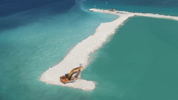 Aerial view of excavators working on land reclamation Maldives.