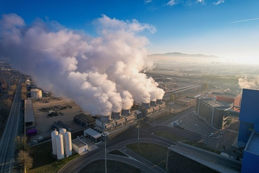 Aerial view of the Termovalorizzatore di Torino waste to energy plant with thick white steam plumes rising from cooling towers against a backdrop of hills Torino Piemonte Italy. Aerial view of the Termovalorizzatore di Torino waste to energy plant with thick white steam plumes rising from cooling towers against a backdrop of hills Torino Piemonte Italy.