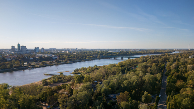 Aerial view of Vistula river flowing through Warsaw with a bridge connecting the banks and the city skyline in the distance Warsaw Poland. Aerial view of Vistula river flowing through Warsaw with a bridge connecting the banks and the city skyline in the distance Warsaw Poland.