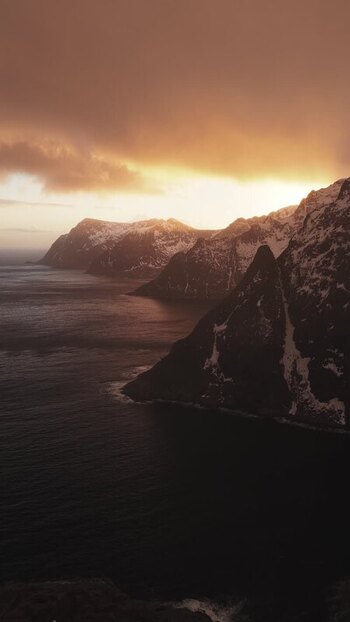 Aerial view of snowy mountains near sea Norway.