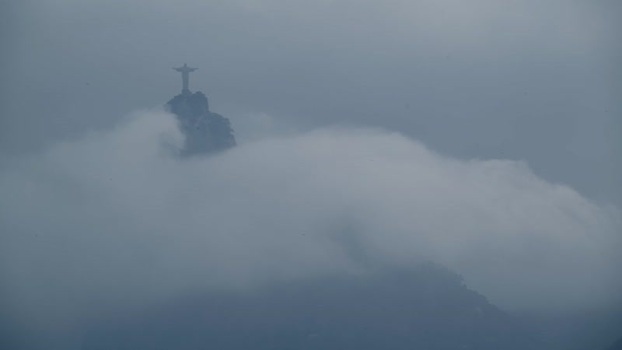 View of Christ the Redeemer statue shrouded in thick clouds Brazil.
