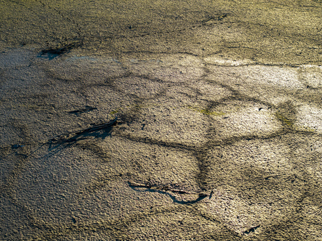 Aerial view of cracked dry earth and mud patterns in Czorsztyn Lesser Poland Voivode Poland. Aerial view of cracked dry earth and mud patterns in Czorsztyn Lesser Poland Voivode Poland.