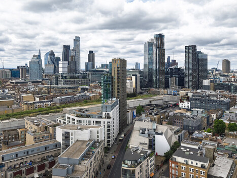 Aerial view of the Shoreditch district featuring a mix of modern skyscrapers and historic brick architecture in the urban landscape of London England United Kingdom. Aerial view of the Shoreditch district featuring a mix of modern skyscrapers and historic brick architecture in the urban landscape of London England United Kingdom.