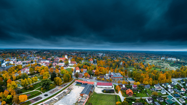 Aerial view of Cesis Castle ruins surrounded by vibrant autumn foliage and historic architecture under a dramatic dark sky in Cesis Cesis Municipality Latvia. Aerial view of Cesis Castle ruins surrounded by vibrant autumn foliage and historic architecture under a dramatic dark sky in Cesis Cesis Municipality Latvia.