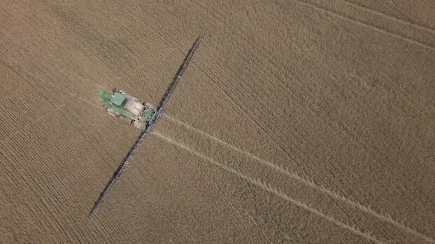 Aerial view of tractor spraying crops in Philadelphia South Africa. Aerial view of tractor spraying crops in Philadelphia South Africa.