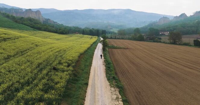 Aerial view of a person walking on a road by Balze del Valdarno Italy. Aerial view of a person walking on a road by Balze del Valdarno Italy.