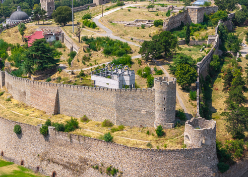 Aerial view of the historic stone walls and defensive towers of the Skopje Fortress surrounded by green spaces and ruins in Skopje Greater Skopje North Macedonia. Aerial view of the historic stone walls and defensive towers of the Skopje Fortress surrounded by green spaces and ruins in Skopje Greater Skopje North Macedonia.