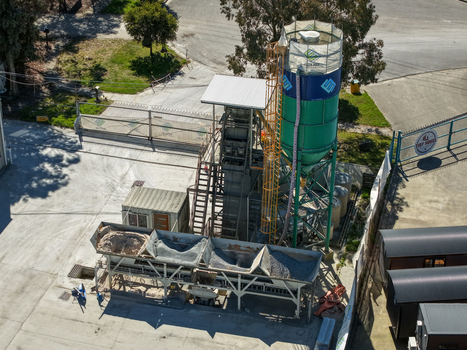 Kilsyth Victoria Australia 20 September 2026 Aerial view of a concrete batching plant featuring a tall green silo aggregate storage bins and an office container in an industrial yard. Kilsyth Victoria Australia 20 September 2026 Aerial view of a concrete batching plant featuring a tall green silo aggregate storage bins and an office container in an industrial yard.