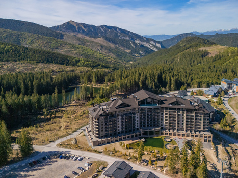 Aerial view of DAMIAN JASNA Hotel Resort Residences surrounded by lush pine forests and mountain peaks in Demanovska Dolina Zilinsky kraj Slovakia. Aerial view of DAMIAN JASNA Hotel Resort Residences surrounded by lush pine forests and mountain peaks in Demanovska Dolina Zilinsky kraj Slovakia.