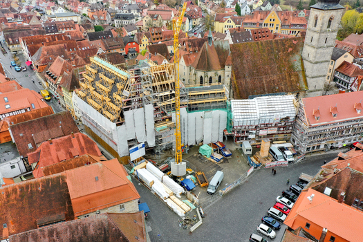 Aerial view of Rathaus Forchheim under renovation with a yellow crane and scaffolding among historic red tiled rooftops in Forchheim Bayern Germany. Aerial view of Rathaus Forchheim under renovation with a yellow crane and scaffolding among historic red tiled rooftops in Forchheim Bayern Germany.