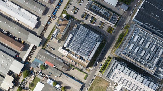 Aerial view of the Equinix Data Center featuring rooftop solar panels surrounded by industrial buildings parking lots and roads in Frankfurt am Main Hessen Germany.