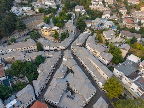 Aerial view of the historic Old Bazaar with traditional stone roofed buildings and narrow streets in Gjirokaster Gjirokaster County Albania. Aerial view of the historic Old Bazaar with traditional stone roofed buildings and narrow streets in Gjirokaster Gjirokaster County Albania.