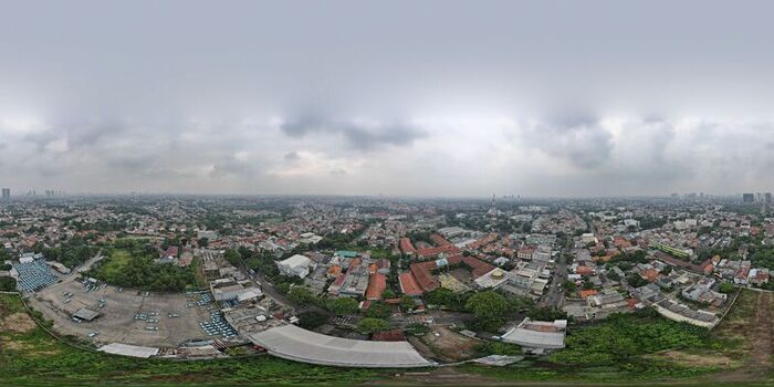Aerial view of Pondok Labu featuring dense residential rooftops lush green trees and urban infrastructure under a cloudy sky in Cilandak Jakarta Indonesia. Aerial view of Pondok Labu featuring dense residential rooftops lush green trees and urban infrastructure under a cloudy sky in Cilandak Jakarta Indonesia.