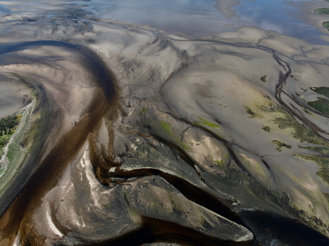 Aerial view of Findhorn Bay showing intricate tidal patterns sandbanks and shallow water channels in Findhorn Scotland United Kingdom. Aerial view of Findhorn Bay showing intricate tidal patterns sandbanks and shallow water channels in Findhorn Scotland United Kingdom.