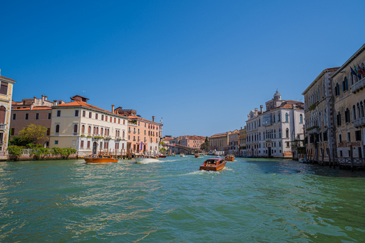 Venice Italy 29 March 2026 View of the Grand Canal shimmering under a bright sky with vaporettos gliding between historic buildings their facades reflecting sunlight in warm hues. Venice Italy 29 March 2026 View of the Grand Canal shimmering under a bright sky with vaporettos gliding between historic buildings their facades reflecting sunlight in warm hues.