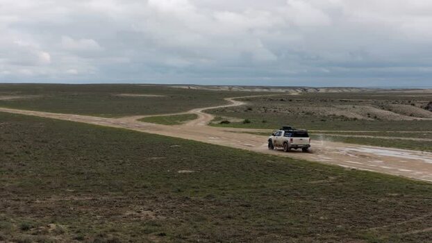 Aerial view of a pickup truck on a dirt road Kazakhstan.