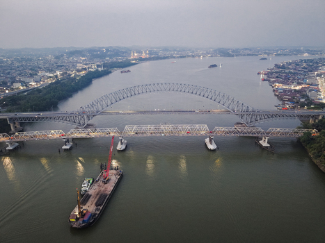 Aerial view of Jembatan Mahakam I and the adjacent bridge spanning the Mahakam River with a barge and crane below in Kecamatan Samarinda Seberang Kalimantan Timur Indonesia. Aerial view of Jembatan Mahakam I and the adjacent bridge spanning the Mahakam River with a barge and crane below in Kecamatan Samarinda Seberang Kalimantan Timur Indonesia.