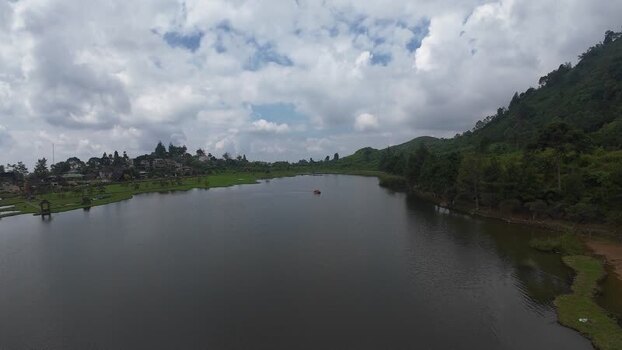Aerial view of Rawa Gede Jonggol Lake and green hills Indonesia.