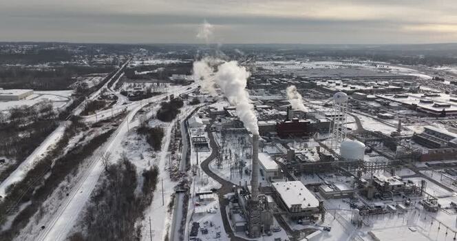 Aerial view of an industrial plant with smoke from a chimney United States. Aerial view of an industrial plant with smoke from a chimney United States.