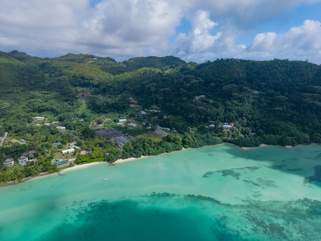 Aerial view of where emerald waters meet lush green hillsides revealing a coastal paradise speckled with buildings Victoria Mahe Island Seychelles. Aerial view of where emerald waters meet lush green hillsides revealing a coastal paradise speckled with buildings Victoria Mahe Island Seychelles.