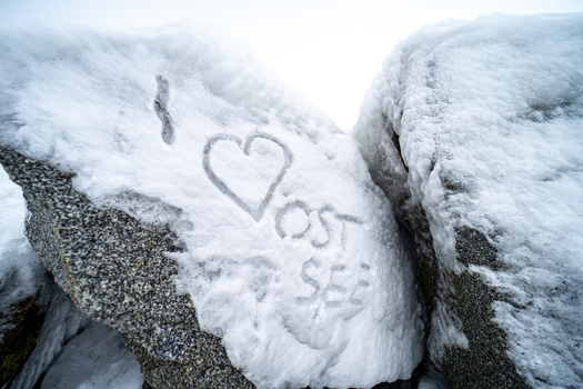 View of a heart shape and the text I love Ostsee carved into the snow on a large rock near the Molenfeuer Sassnitz Sassnitz Mecklenburg Vorpommern Germany.