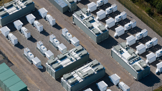Aerial view of Pelham Storage Limited featuring rows of industrial battery storage units and electrical infrastructure on a gravel site in Bishop s Stortford England United Kingdom. Aerial view of Pelham Storage Limited featuring rows of industrial battery storage units and electrical infrastructure on a gravel site in Bishop s Stortford England United Kingdom.