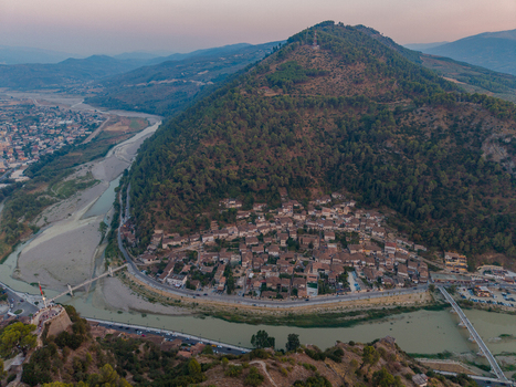 Aerial view of the historic town of Berat with its traditional Ottoman style houses nestled along the Osum River under a soft evening sky in Berat Berat County Albania. Aerial view of the historic town of Berat with its traditional Ottoman style houses nestled along the Osum River under a soft evening sky in Berat Berat County Albania.