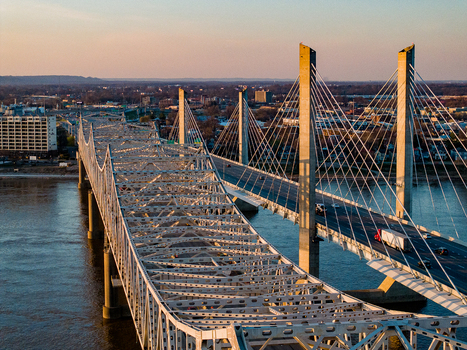 Aerial view of the Abraham Lincoln Bridge and Kennedy Bridge crossing the Ohio River with the city skyline during golden hour in Louisville Kentucky United States. Aerial view of the Abraham Lincoln Bridge and Kennedy Bridge crossing the Ohio River with the city skyline during golden hour in Louisville Kentucky United States.