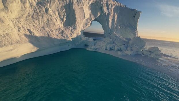 FPV aerial view of arch iceberg Greenland. FPV aerial view of arch iceberg Greenland.