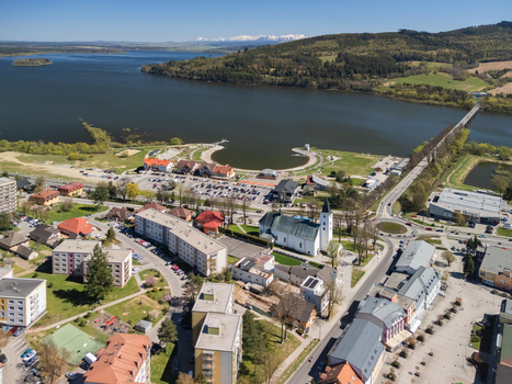 Aerial view of the Roman Catholic Church of Saints Simon and Jude the Orava Reservoir and residential buildings in Namestovo Zilina Region Slovakia. Aerial view of the Roman Catholic Church of Saints Simon and Jude the Orava Reservoir and residential buildings in Namestovo Zilina Region Slovakia.