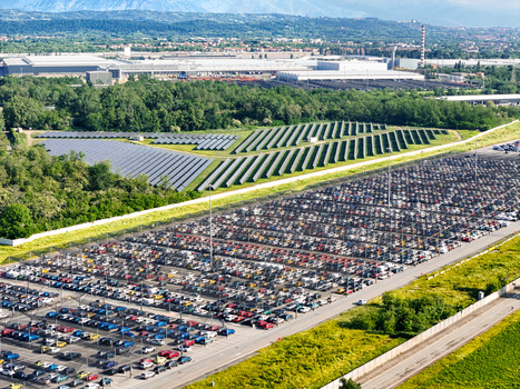 Aerial view of the large car storage lot and solar panel arrays at the industrial plant in Rivalta di Torino Piedmont Italy. Aerial view of the large car storage lot and solar panel arrays at the industrial plant in Rivalta di Torino Piedmont Italy.
