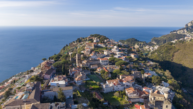 Aerial view of sun drenched villas cascade down the verdant slopes towards the azure sea a timeless Italian vista Ravello Campania Italy. Aerial view of sun drenched villas cascade down the verdant slopes towards the azure sea a timeless Italian vista Ravello Campania Italy.