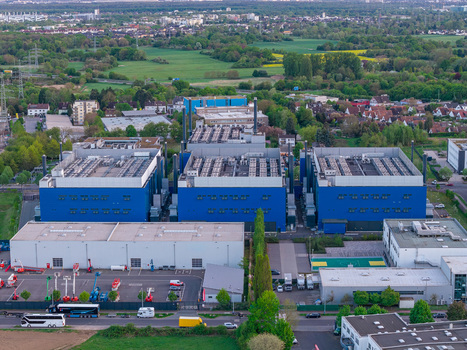Aerial view of the Digital Realty Frankfurt FRA30 data center complex with blue industrial buildings and cooling systems in Frankfurt am Main Hessen Germany. Aerial view of the Digital Realty Frankfurt FRA30 data center complex with blue industrial buildings and cooling systems in Frankfurt am Main Hessen Germany.