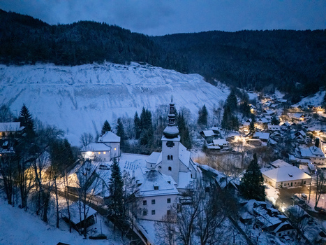 Aerial view of the historic mining village of Spania Dolina with its snow covered church and traditional houses at twilight in Spania Dolina Banska Bystrica Region Slovakia. Aerial view of the historic mining village of Spania Dolina with its snow covered church and traditional houses at twilight in Spania Dolina Banska Bystrica Region Slovakia.