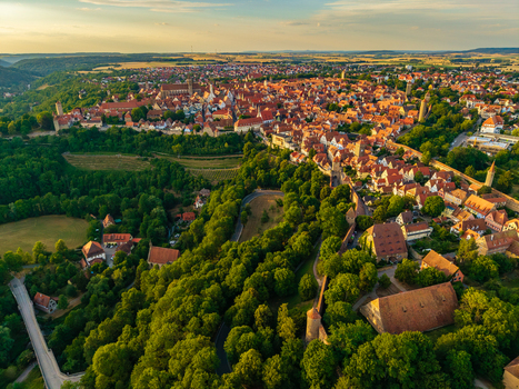 Aerial view of the historic medieval town of Rothenburg ob der Tauber with iconic red tiled rooftops ancient fortifications and lush greenery Rothenburg ob der Tauber Bavaria Germany. Aerial view of the historic medieval town of Rothenburg ob der Tauber with iconic red tiled rooftops ancient fortifications and lush greenery Rothenburg ob der Tauber Bavaria Germany.
