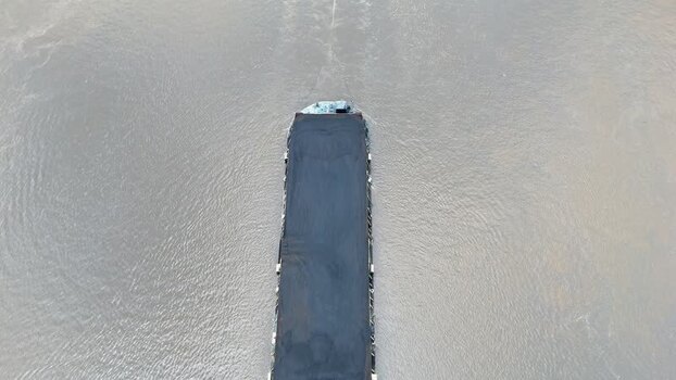 Aerial view of coal barge on river in Indonesia.