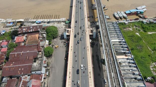 Aerial view of the Ampera Bridge with traffic and light rail transit tracks crossing the Musi River in Kecamatan Seberang Ulu I Sumatera Selatan Indonesia. Aerial view of the Ampera Bridge with traffic and light rail transit tracks crossing the Musi River in Kecamatan Seberang Ulu I Sumatera Selatan Indonesia.