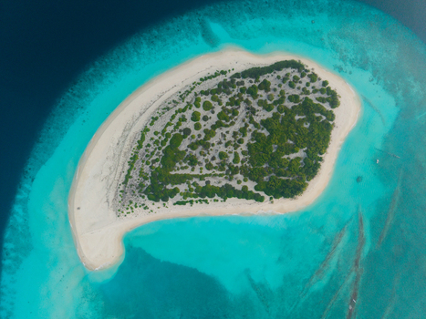 Aerial view of the island with white sands and lush green vegetation surrounded by the turquoise ocean Hoarafushi Thiladhunmathee Uthuruburi Maldives. Aerial view of the island with white sands and lush green vegetation surrounded by the turquoise ocean Hoarafushi Thiladhunmathee Uthuruburi Maldives.