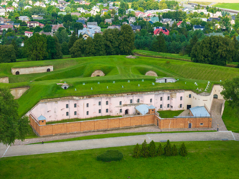 Aerial view of the historic Ninth Fort in Kaunas featuring its distinctive pink walls brick perimeter and grassy ramparts surrounded by lush greenery in Kaunas Kaunas County Lithuania.