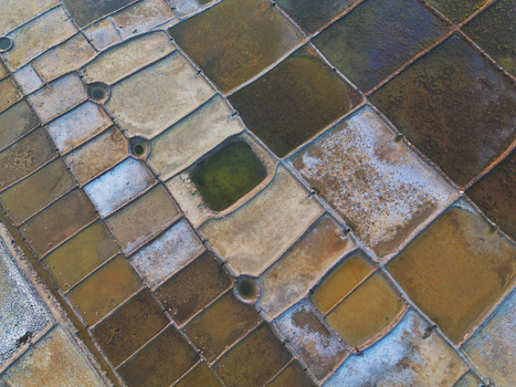 Aerial view of geometric salt pans with varying colors and textures in the coastal landscape of Moheskhali Upazila Chittagong Division Bangladesh. Aerial view of geometric salt pans with varying colors and textures in the coastal landscape of Moheskhali Upazila Chittagong Division Bangladesh.