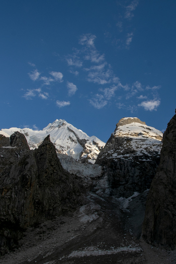 View of Goro II campsite surrounded by snow capped peaks rocky slopes and glacial terrain under a clear blue sky in the Karakoram range Gilgit Pakistan. View of Goro II campsite surrounded by snow capped peaks rocky slopes and glacial terrain under a clear blue sky in the Karakoram range Gilgit Pakistan.