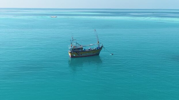 Aerial view of a fishing boat in the turquoise sea Maldives. Aerial view of a fishing boat in the turquoise sea Maldives.
